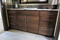 Thumb vanity  contemporary style  quartersawn walnut  dark color  banded door  bank of drawers  single sink  full overlay