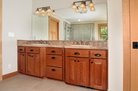 Thumb vanity  craftsman style  cherry  raised panel  light color  angled bump out sinks  master bath  standard overlay