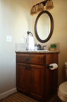 Thumb vanity  traditional style  knotty alder  dark color  raised panel  single sink  full overlay