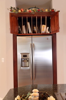 Thumb kitchen  traditional style  cherry  raised panel with arch  cherry color  tray dividers above refrigerator