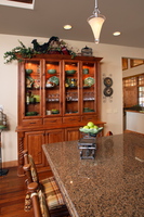 Thumb kitchen  traditional style  knotty alder  medium color  raised panel  china area  glass doors  turned posts  flutes  full overlay