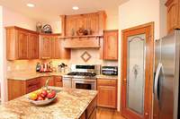 Thumb kitchen  traditional style  knotty oak  medium color  raised panel with arch  wood hood  standard overlay